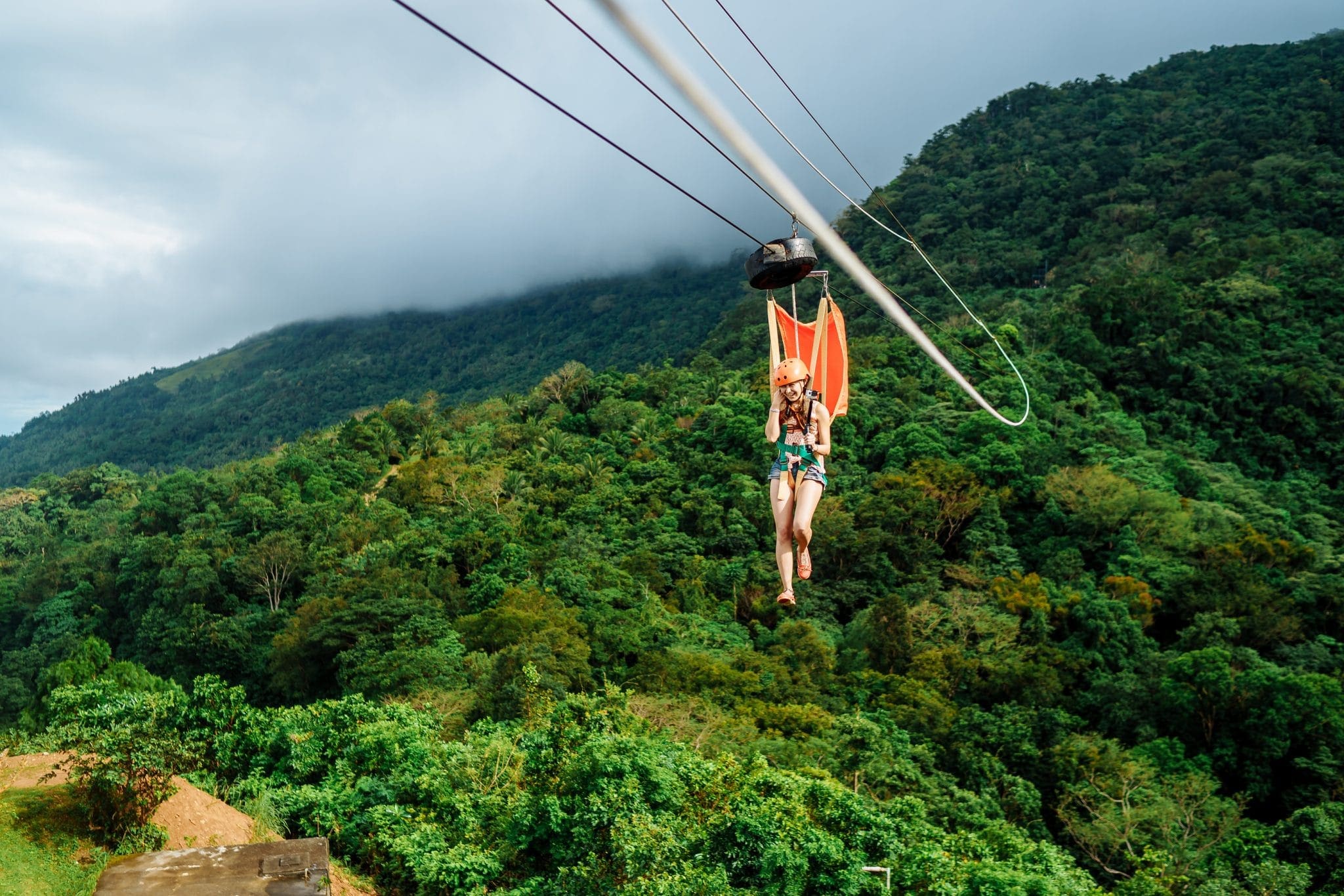 Adult woman, Zip line adventure at Mountain lake resort in Mindoro Philippines